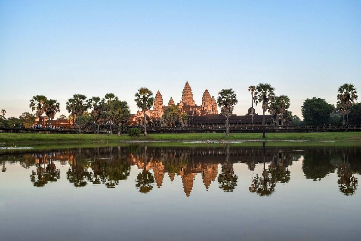 Angkor Wat seen across the moat under a wide evening sky