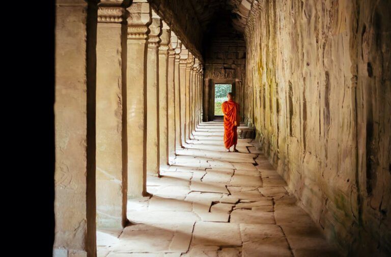 Sunlit stone colonnade of an Angkor temple