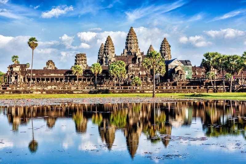 Angkor Wat and its five towers mirrored in the reflecting pool at sunrise