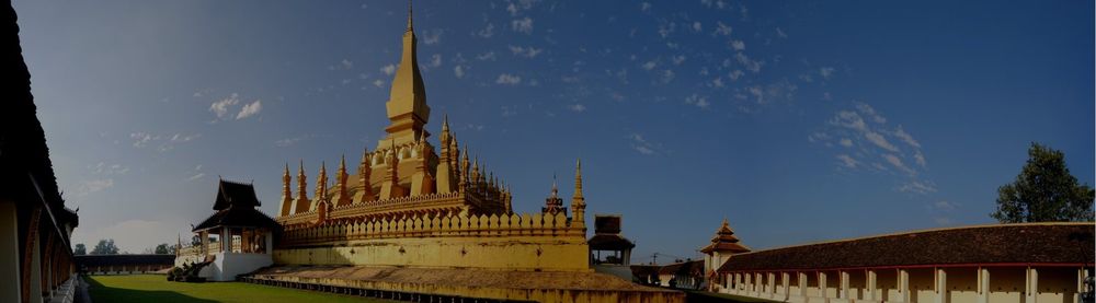 The golden stupa of Pha That Luang silhouetted at dusk