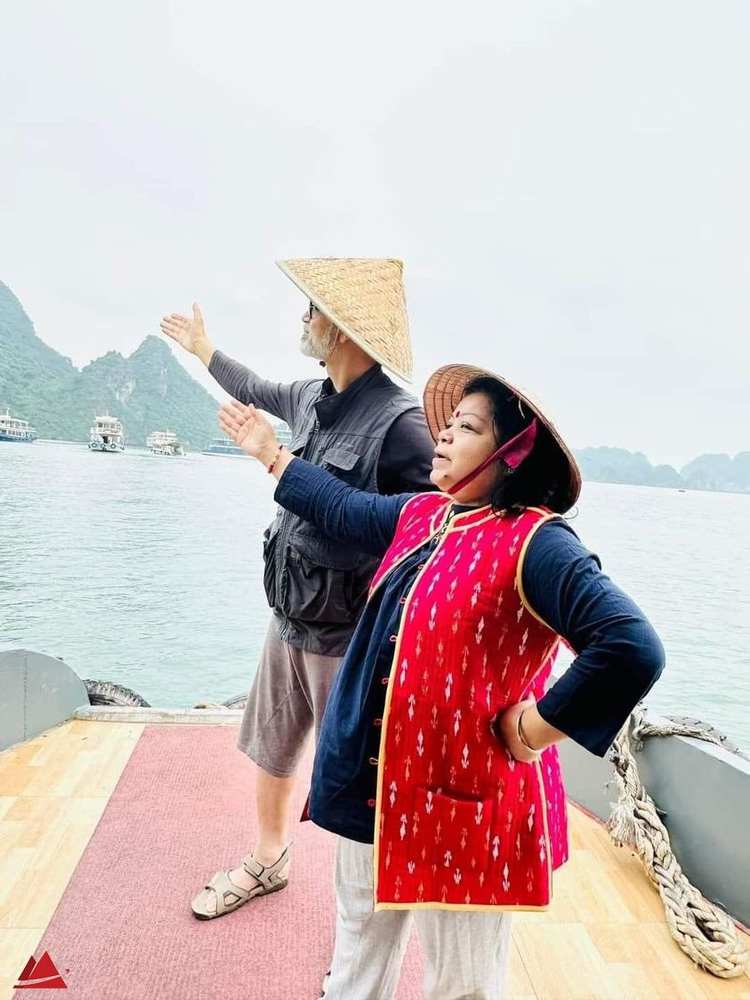 Two travellers on a cruise deck looking out over the bay