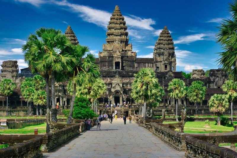 Palm-lined causeway leading to the towers of Angkor Wat