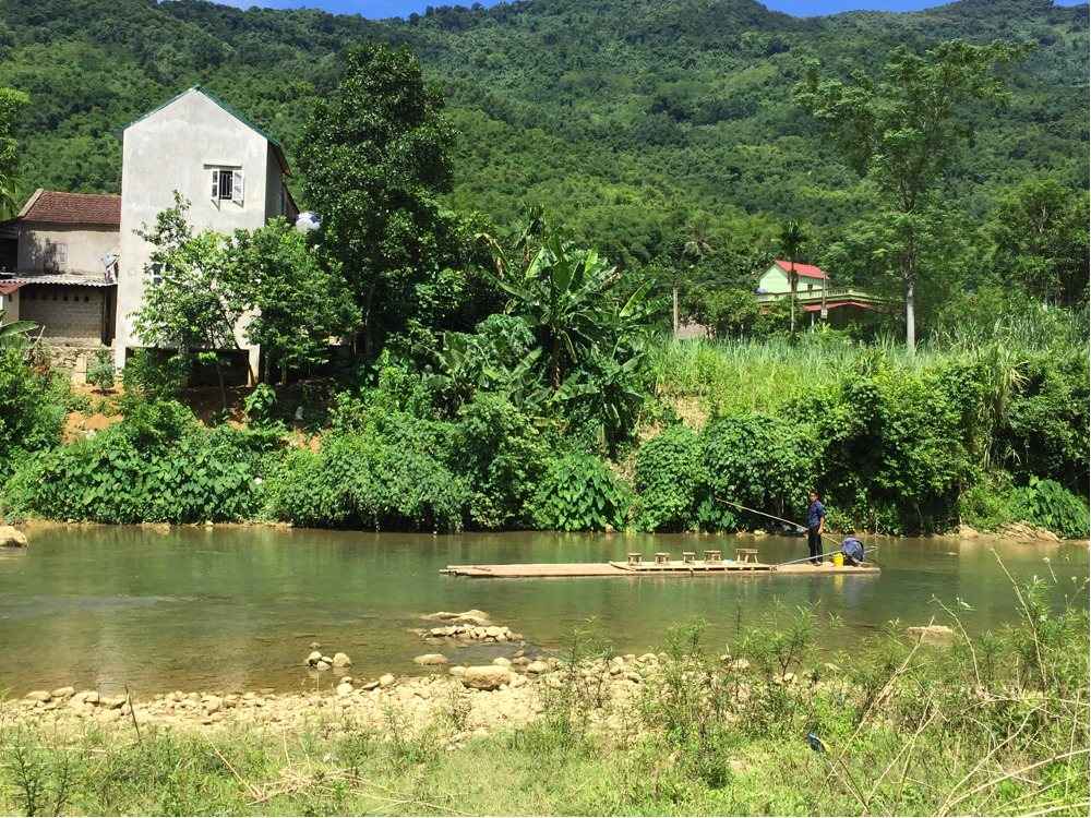 River bend with a village and forest on the far bank