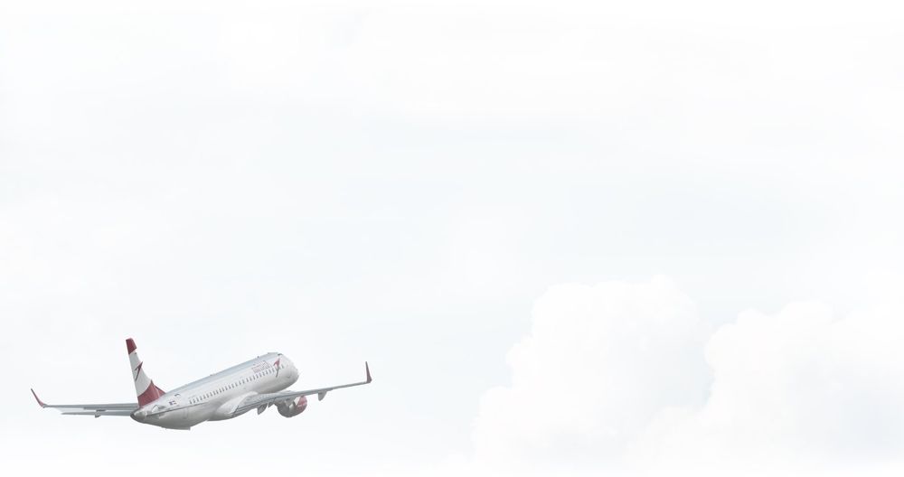 Passenger jet climbing through high cloud
